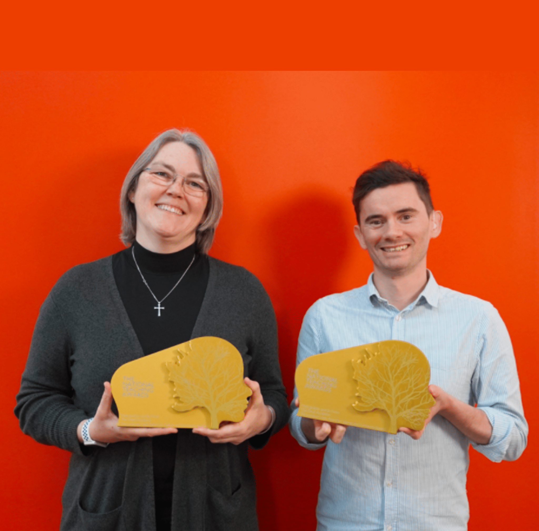 Deaf Academy teachers Jo Fison and Matt Stocks holding their Lockdown Hero 2021 awards.